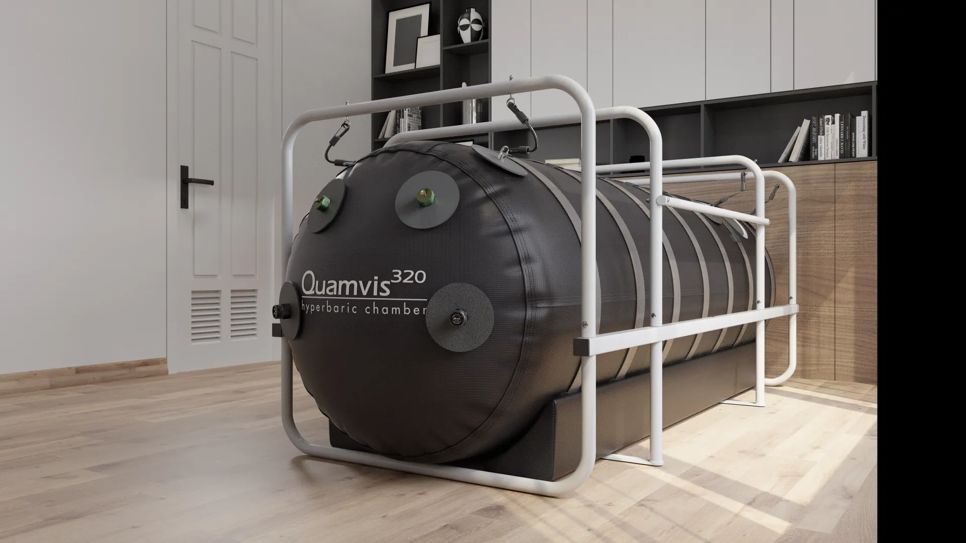 A Quamvis 320 hyperbaric chamber, dark grey and cylindrical, encased in a white metal frame, sits on a wooden floor in a modern room with shelving and a white door.